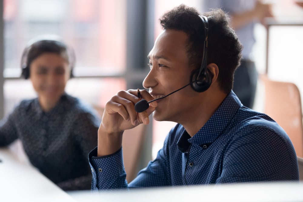 A sales professional speaks with a customer on the phone